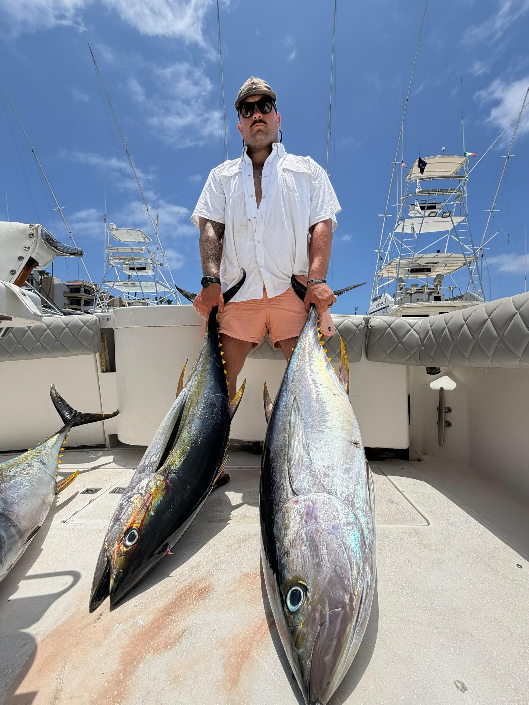 Nasty Sport Fishing angler with twin yellowfin tuna on deck in Cabo